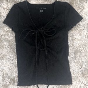 Cute black shirt with ties in the front.